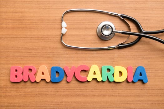 Bradycardia colorful word with stethoscope on the wooden background