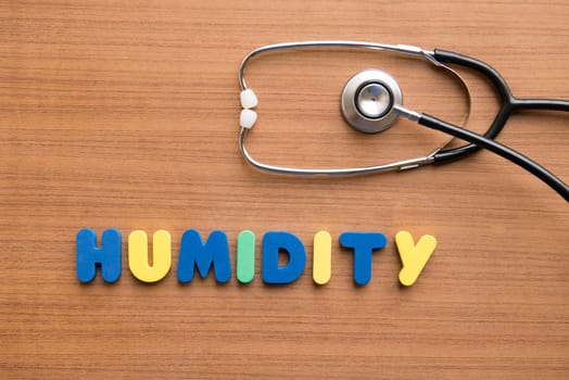 Humidity colorful word with stethoscope on the wooden background