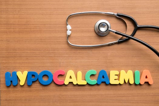 Hypocalcaemia colorful word with stethoscope on the wooden background