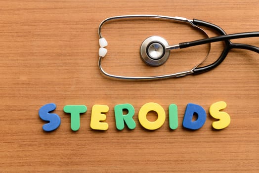 Steroids colorful word on the wooden background