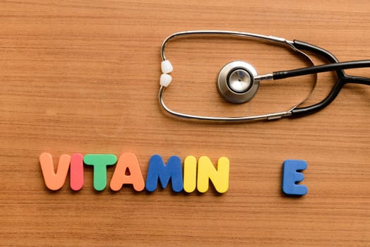 vitamin E colorful word on the wooden background