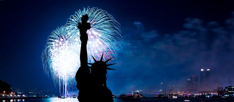 The silhouette of Statue of Liberty Statue of Liberty and July 4th fireworks over Hudson River