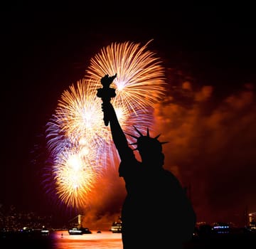 The silhouette of Statue of Liberty Statue of Liberty and July 4th fireworks over Hudson River