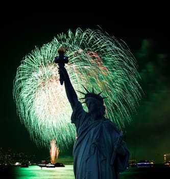 The silhouette of Statue of Liberty Statue of Liberty and July 4th fireworks over Hudson River