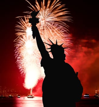 The silhouette of Statue of Liberty Statue of Liberty and July 4th fireworks over Hudson River