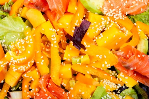 Asian salad with salted salmon, mango, sesame and vegetables.Salad and chopsticks. Space for text