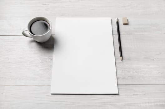 Blank branding stationery set. White letterhead, coffee cup, pen and eraser.