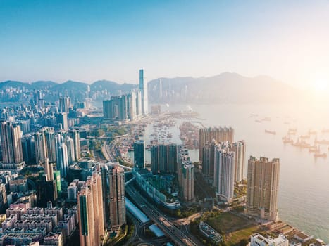 Top view aerial photo from flying drone of a developed Hong Kong city with modern skyscrapers with contemporary design. China town with business and financial centers and road with cars - Image