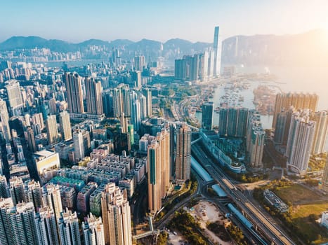 Top view aerial photo from flying drone of a developed Hong Kong city with modern skyscrapers with contemporary design. China town with business and financial centers and road with cars - Image