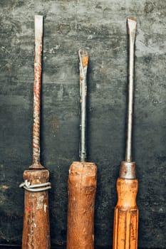 Screwdrivers. Set of old screwdrivers on steel surface. Mechanic tools for maintenance. Hardware tools to fix. Technical background with copy space
