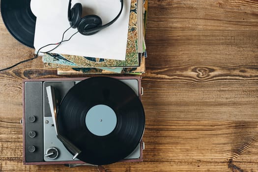 Listening to music from vinyl record. Playing music from analog disk on turntable player. Enjoying music from old collection. Relaxing at home. Retro and vintage. Audio stereo equipment. Analog sound. Ready for content