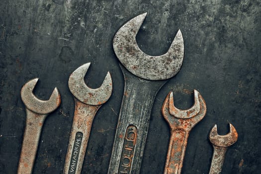 Spanners on steel surface. Old rusty wrenches for maintenance. Mechanic hardware tools to fix. Technical tools background with copy space