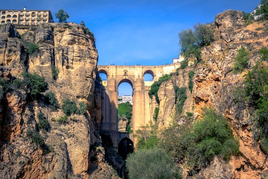 Famous view on the Puente Nuevo crossing the El Tajo Canyon in Ronda, cozy historical city in Andalusia, Spain