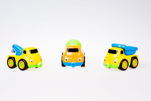 Little toy cars team on white background