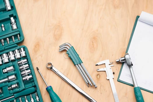Workshop table with many tools. Wrench, spanner, calliper and ratchet with many attachments. Work tools. Universal tool set. Professional equipment. Background