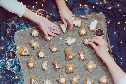 Decorating Christmas gingerbread cookies. View from above