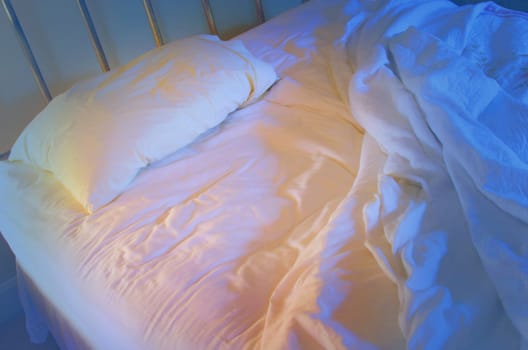 Unmade lonely bed .