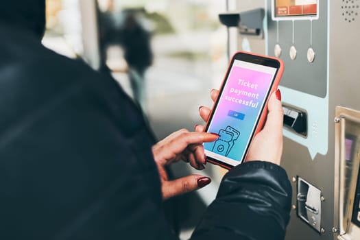 Woman buying ticket at ticket machine paying using mobile payment app on smartphone. Female buying bus public transpoort ticket in vending machine. Person purchasing car parking ticket using mobile phone