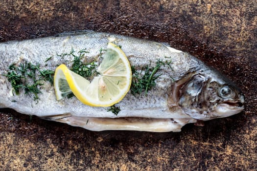 Fresh trout dish with lemon on wooden board