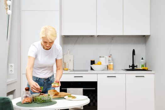 Healthy ageing concept. Adult woman makes healthy food.
