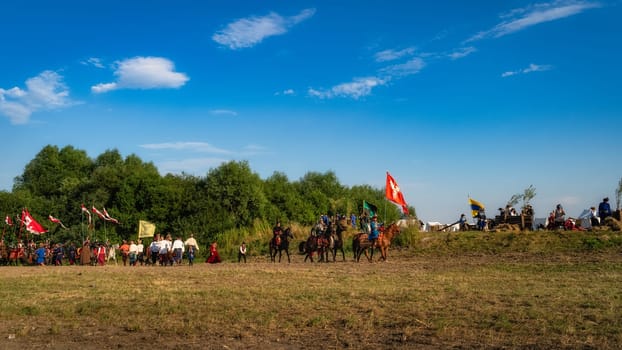 Gniew, Poland, Aug 2020 Polish hors cavalry, Hussars, riding on a battlefield with pendants and flags, historical reenactment of Battle of Gniew