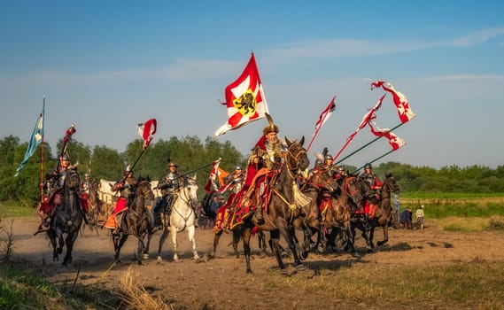 Gniew, Poland, Aug 2020 Castellan leading the charge of the Hussars, polish heavy cavalry, on enemy forces, historical reenactment of Battle of Gniew