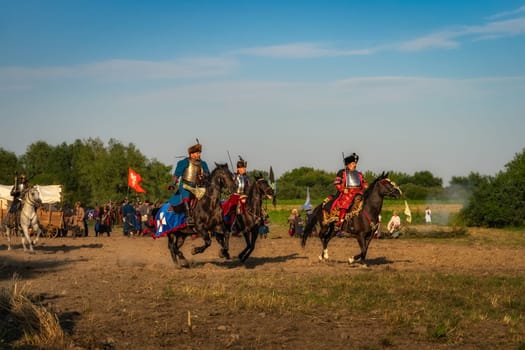 Gniew, Poland, Aug 2020 Horse riders, the hussars, polish heavy cavalry riding through the battlefield, historical reenactment of Battle of Gniew