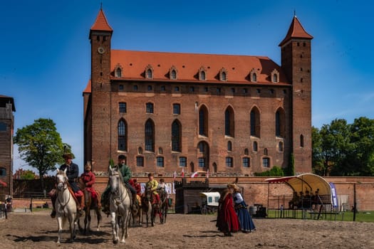 Gniew, Poland, Aug 2020 Polish Hussars, horseman warriors at Castle Gniew courtyard, horseback riding show, historical reenactment