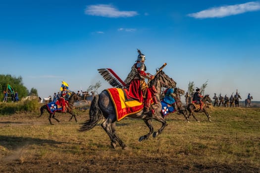 Gniew, Poland, Aug 2020 Polish heavy cavalry, Hussars, attacking Swedish fortifications, historical reenactment of Battle of Gniew from 16th century
