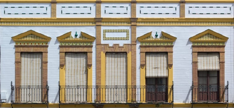 Ronda, Spain, April 2023: Front view of typical and classic building and windows with blinds and tiles in the Spanish and Andalusian city of Ronda