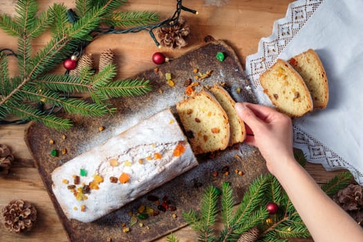 Famale hand taking the piece of Christmas cake