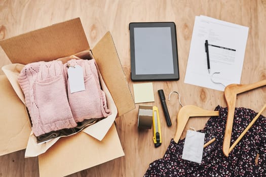 Packing online order to delivery to customer. Preparing parcel box with clothes product from online shop
