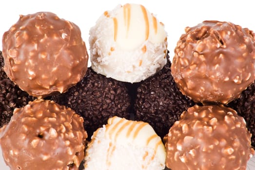 Several ball chocolates over white background