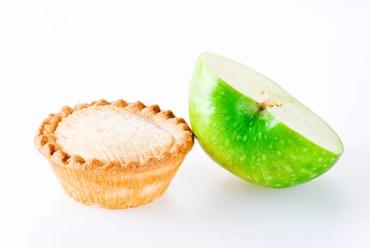 Freshly made apple pie and half of apple over white background
