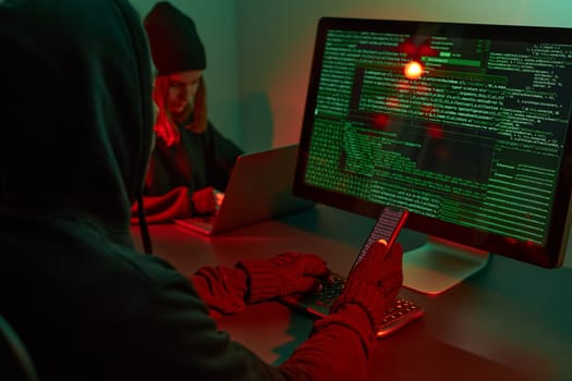 Anonymous people using computer and programming to break code. Cyber security threat. Internet and network security. Access to private information. Anonymous hackers using technology to access to password and encrypted data. Cyber attack