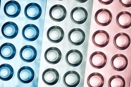 Tablets and capsules pill in blister packaging arranged in row. Medicines - tablets, pills in blister pack, medications drugs. Pharmaceutical industry concept. Pharmacy drugstore. Background with copy space