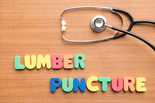 Lumbar puncture (LP) colorful word with stethoscope on the wooden background