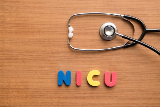 NICU colorful word with stethoscope on the wooden background