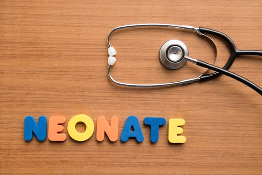 Neonate colorful word with stethoscope on the wooden background
