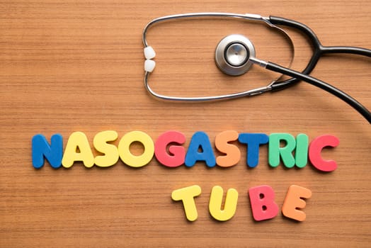 Nasogastric tube colorful word with stethoscope on the wooden background