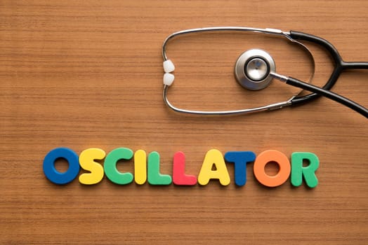 Oscillator colorful word with stethoscope on the wooden background