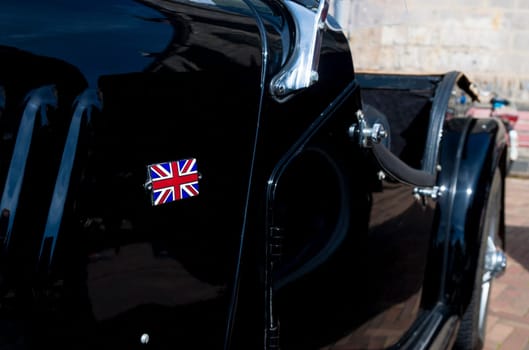 black oldtimer car with brittish flag during the 14th orange tour. This annual tour takes places during the king's birthday celebrations, a national holiday.