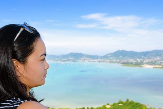 Side of the women tourist looking at beautiful nature sea and island on Khao-Khad mountain viewpoint famous attractions in Phuket Province, Thailand