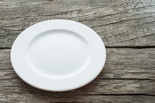 Empty plate on rustic wooden table