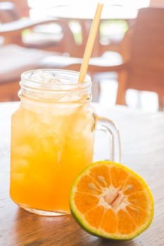 Fresh orange juice serving on wooden table, stock photo