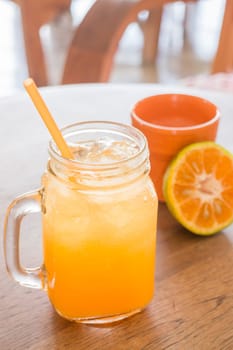 Fresh orange juice serving on wooden table, stock photo