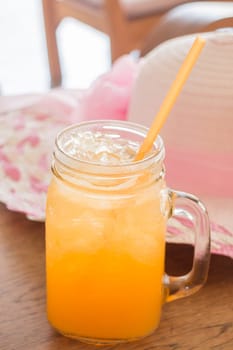 Fresh orange juice serving on wooden table, stock photo