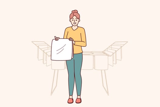 Woman housewife stands near dryer with clean towels doing household chores to create comfort in apartment. Housewife girl with washed item for advertising washing powder or aromatic laundry gel