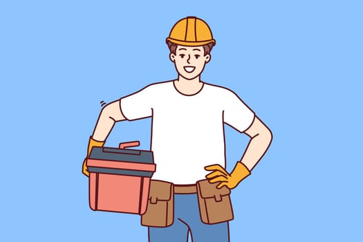 Male foreman holds case of working tools for furniture repair or plumbing work and looks at screen with smile. Guy in helmet of builder works as foreman or builder providing professional services
