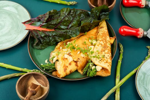 Egg omelet stuffed with green asparagus, cheese and herbs.
